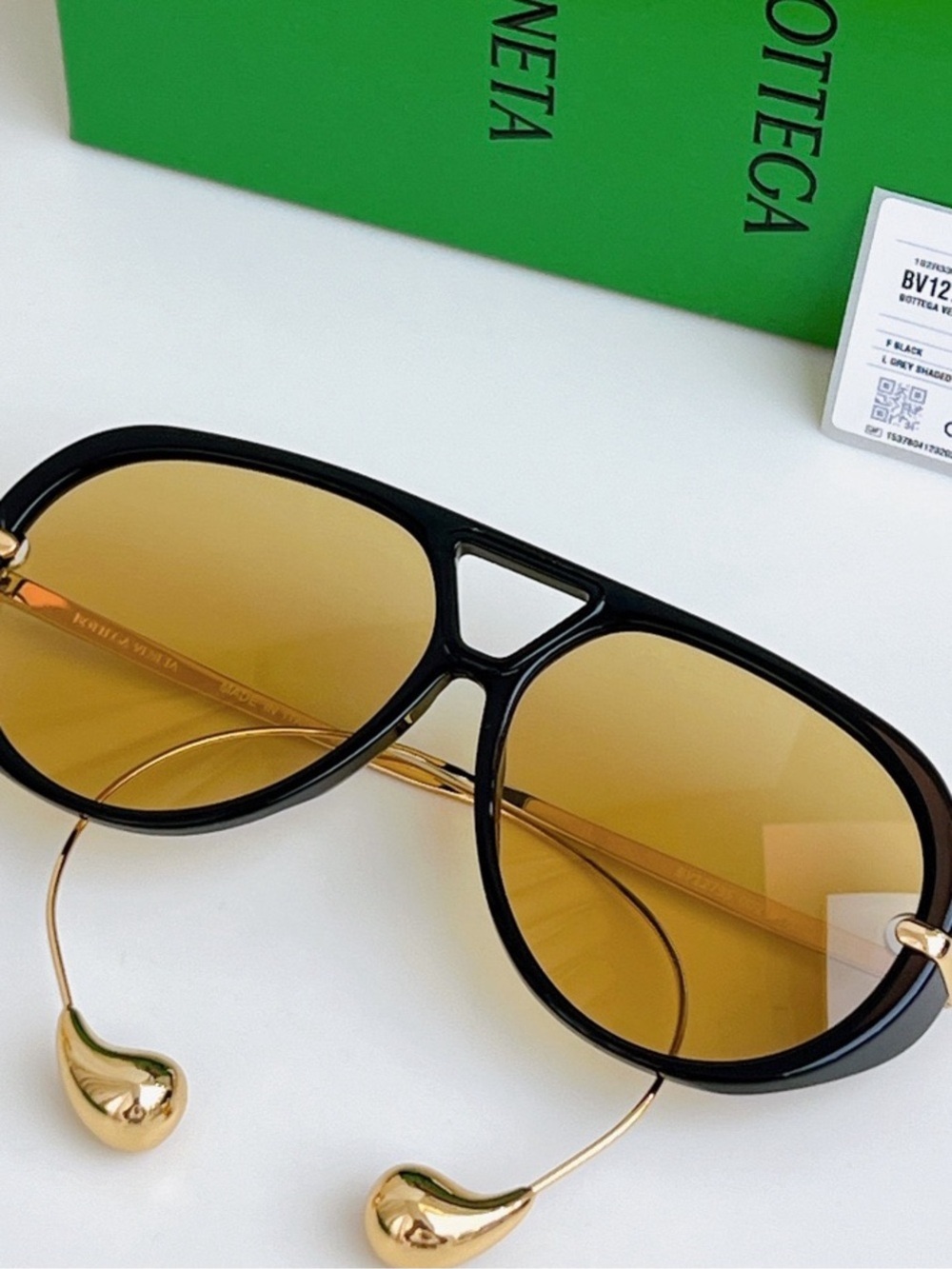 Bottega Veneta Black Frame Sunglasses with Amber Lenses and Gold Details